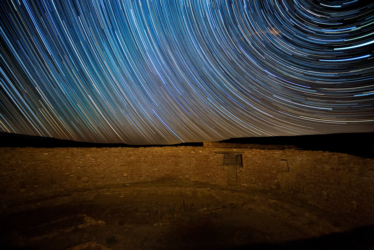 Star trails over Casa Rinconada Star trails over a masonry wall.