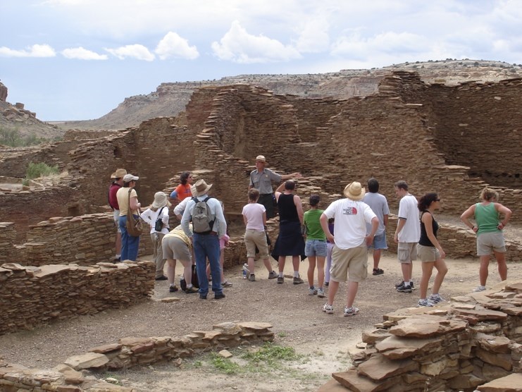 Photo of Park Ranger Kirk Prtrtson with visitors at Pueblo Bonito