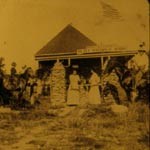 Stone building with a group of people in front
