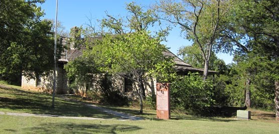 Stone building obscured by trees