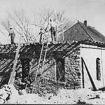 Men working on an old stone building