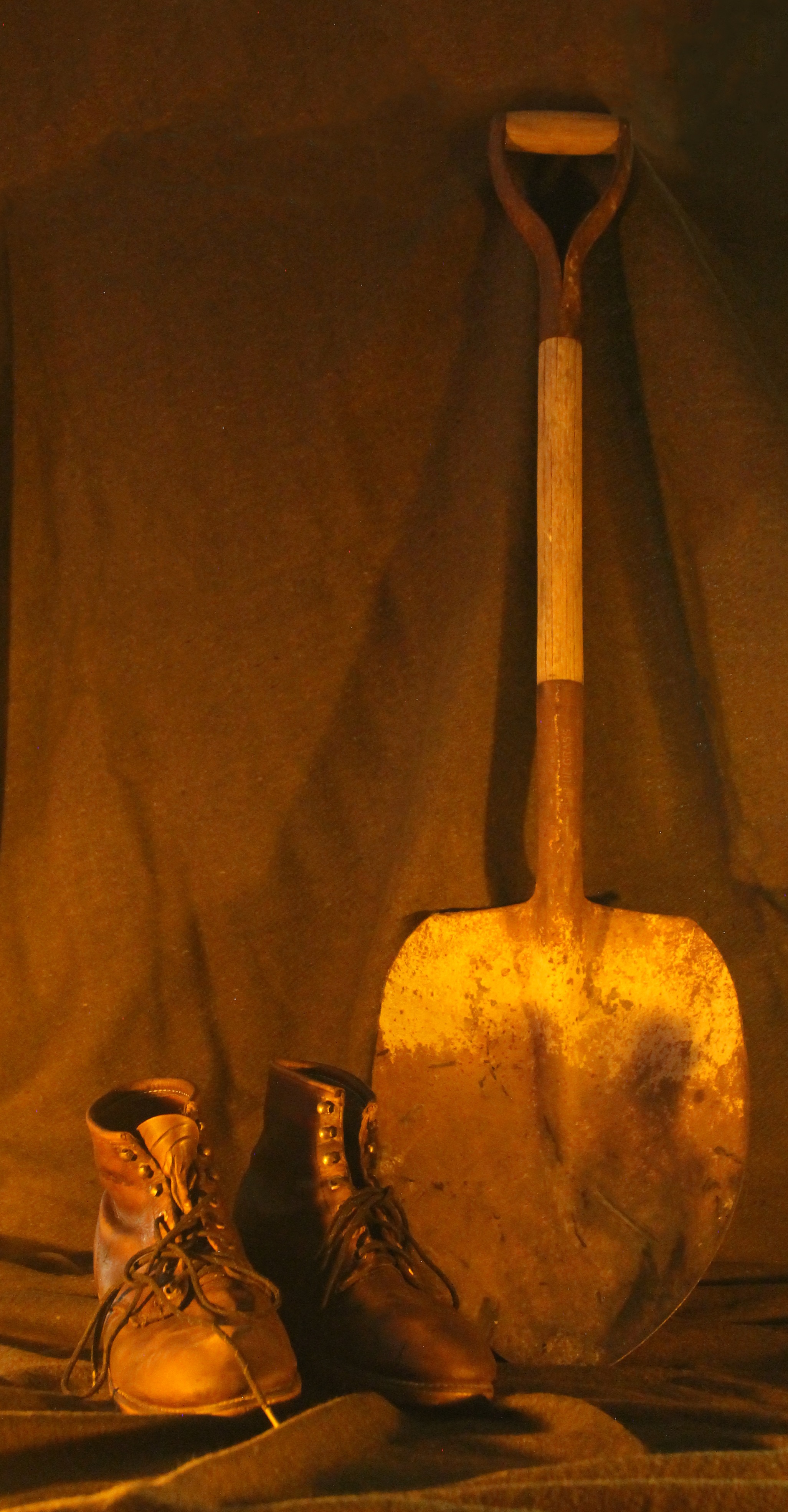 2023 Candlelight Tour - NPS Photo A rusty shovel and two leather boots in front of an army green backdrop