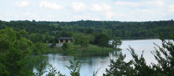 Lake scene with samll pavilion structure visible in the distance