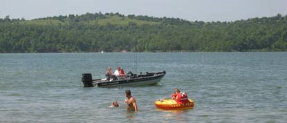 Boat and swimmers in the lake