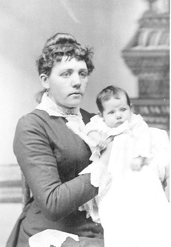 Black and white portrait of a mother holding her baby.