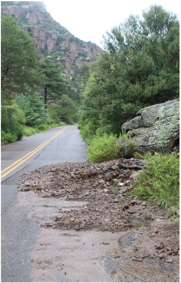 Rocks from hillside on paved road