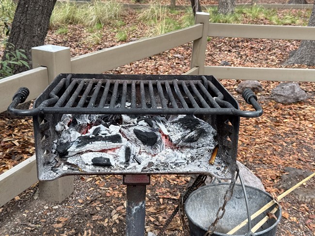 square metal stand up grill in campground