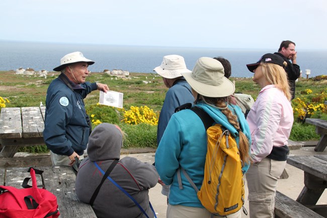 Park volunteer leading hike for visitors. Park volunteer leading hike for visitors.
