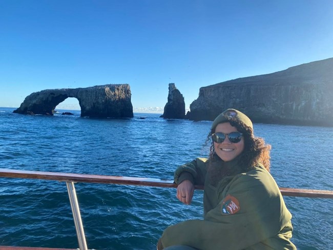 lt= woman on boat with arch in background