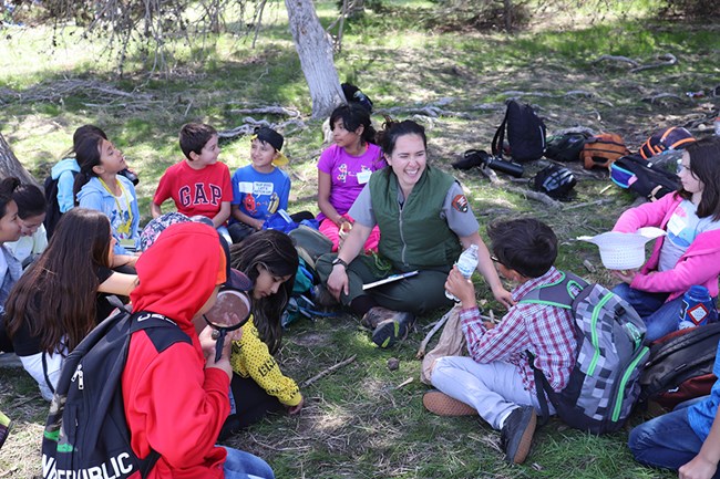 ranger with kids in forest