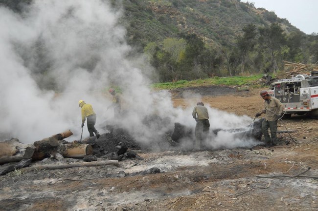 Firefighters surrounded by smoke. Firefighters surrounded by smoke.