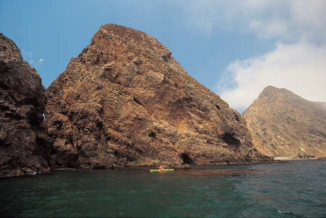 960 channel islands-43 Kayaker against diamond shaped hills.