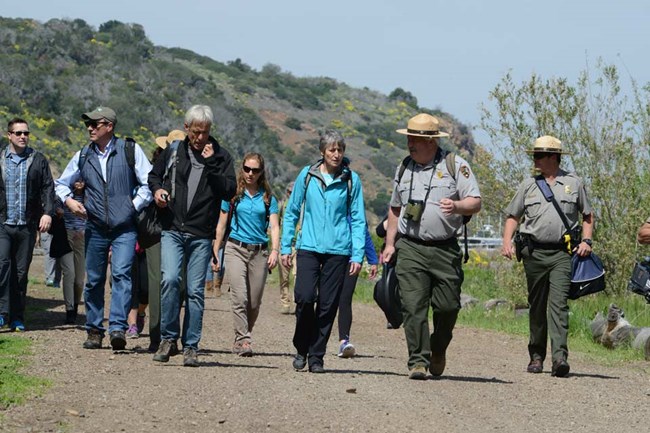 News staff walking with rangers. News staff walking with rangers.