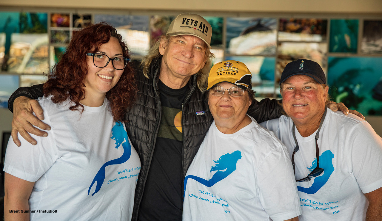 man standing with three women for closeup photo