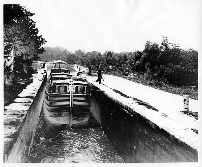 boat being guided into lock