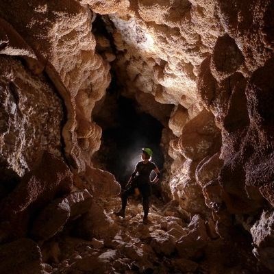 Geoscientist-in-Park intern pictured in a cave.
