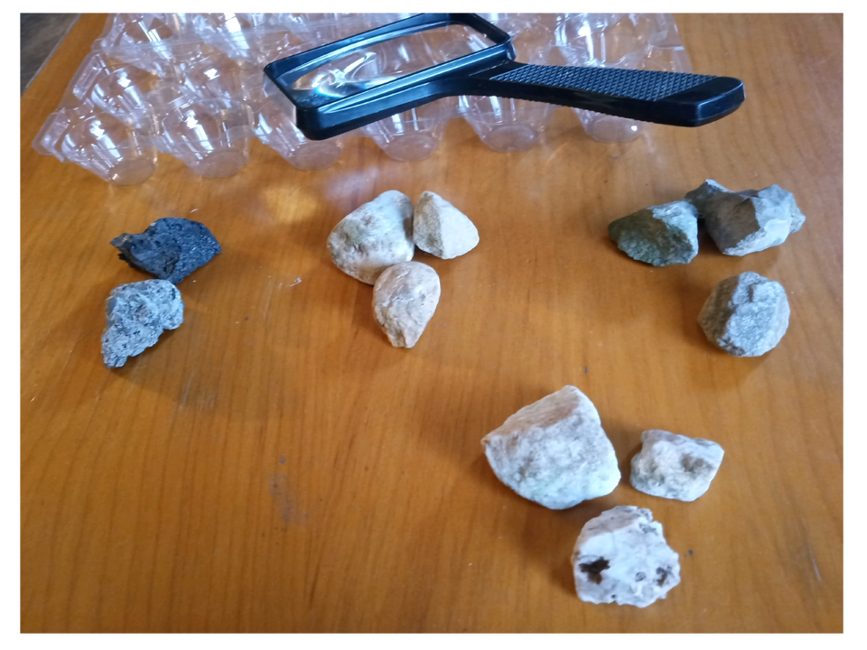 Sorting Rocks by Color with magnifying glass nearby.