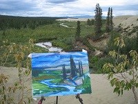 Artwork - a painting of a river and spruce trees - in front of the scenery that inspired it.