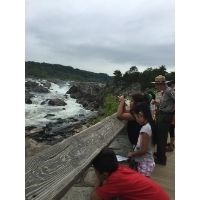 Youth observing the rushing water at Great Falls with a Park Ranger.