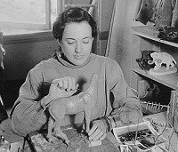 historic photo of woman sculpting a wax horse.