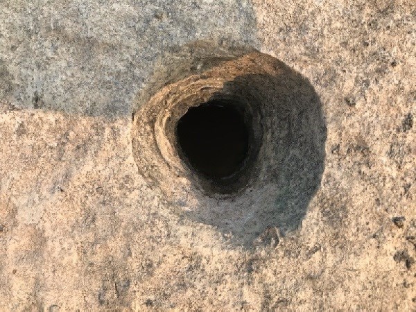 Small pothole in limestone boulder