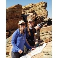 Park interns standing in front of slabs of sandstone.