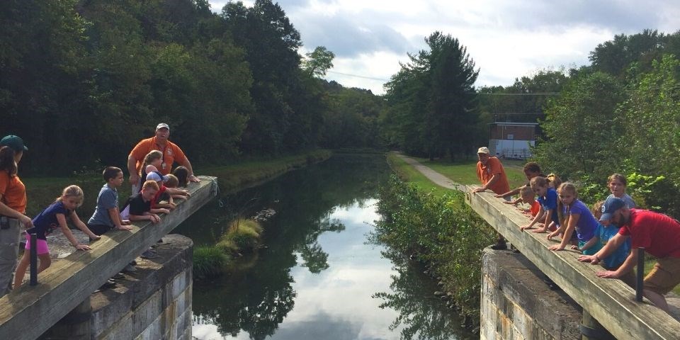 Students surrounding the mitre lock at the C&O Canal.