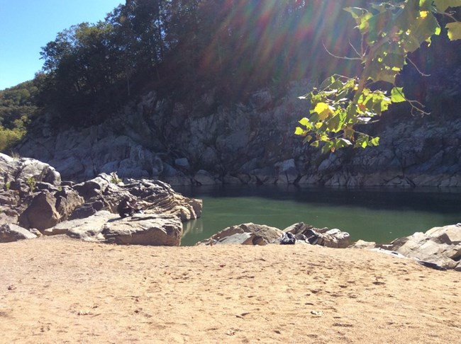 Couple relaxes on rocks of Purplehorse Beach