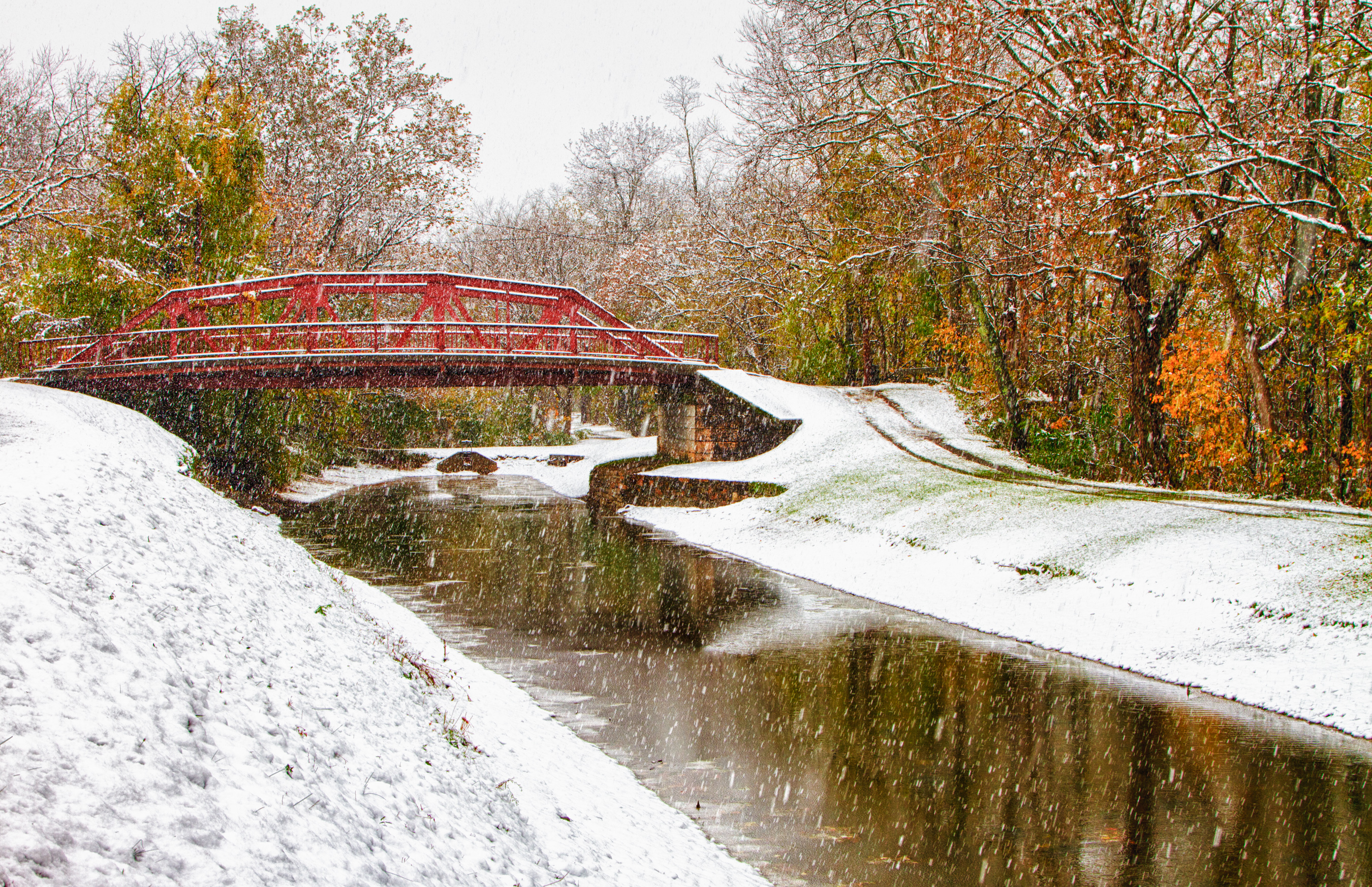 Snow falls over a red bridge near Hancock.