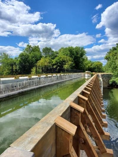 Newly restored Conococheague Aqueduct in Williamsport against a background of blue skies.