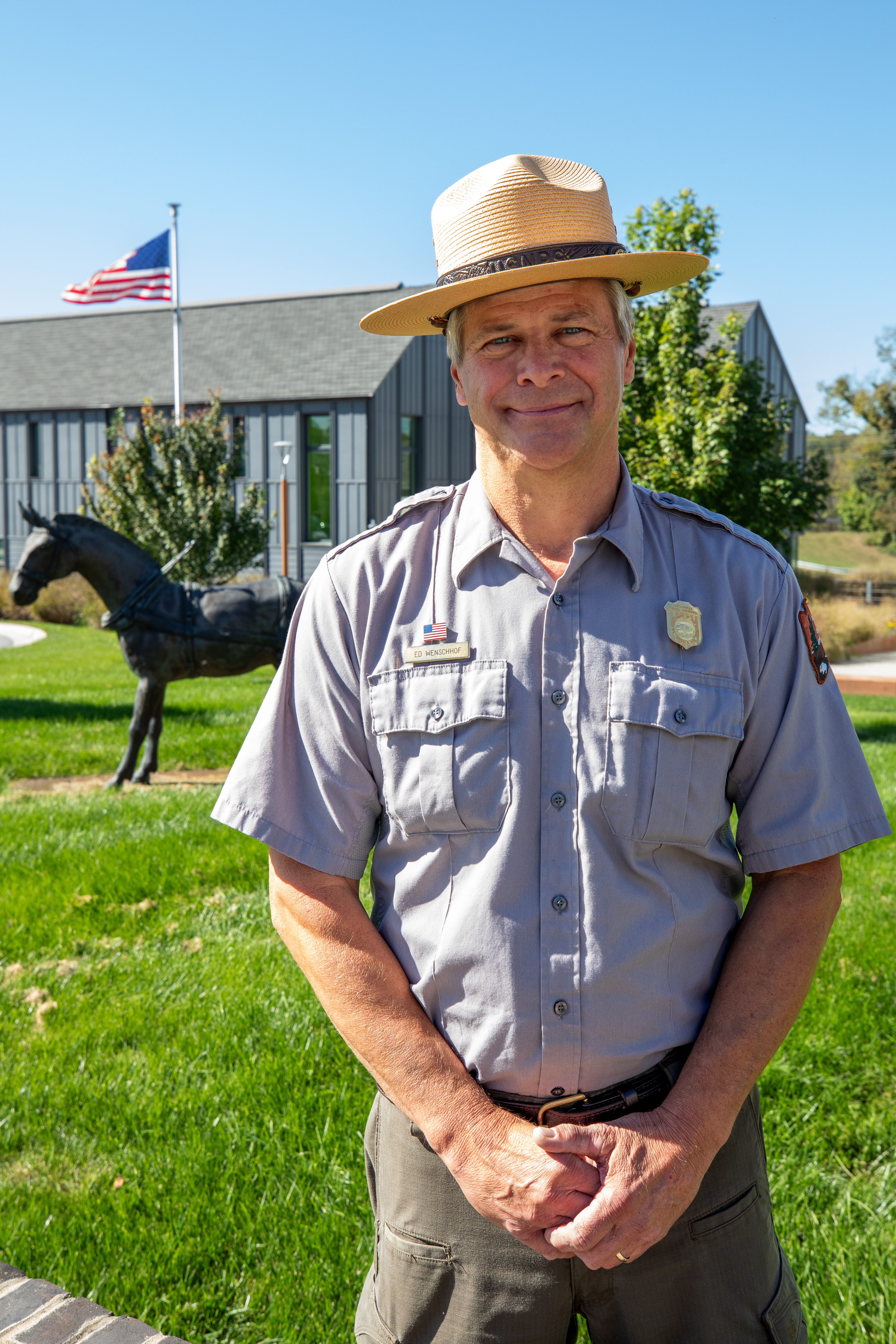 Superintendent Ed Wenschhof standing in front of park headquarters