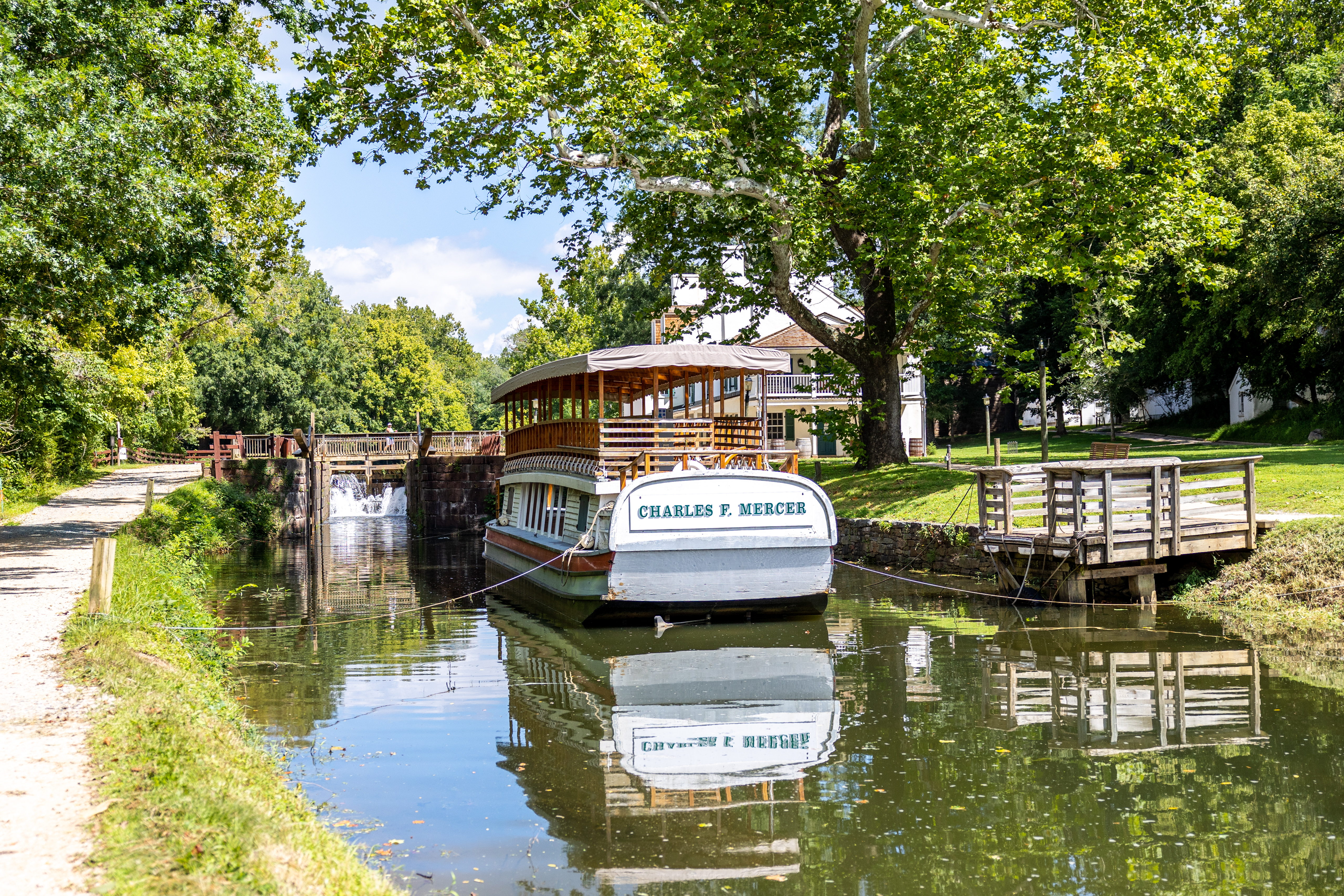 A historic replica of a Canal Boat sits in the watered canal below Lock 20.