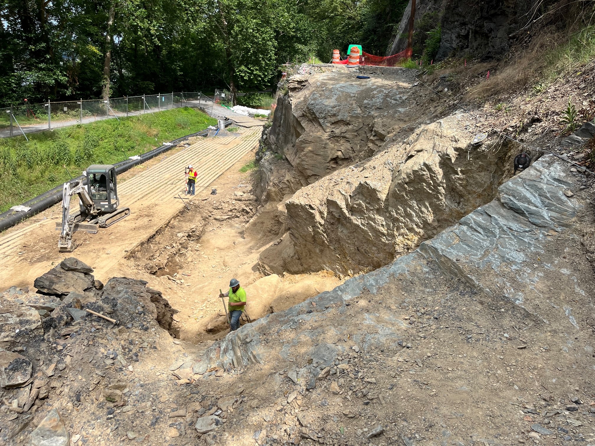 The contractor works on repairs to a dry-laid stone wall