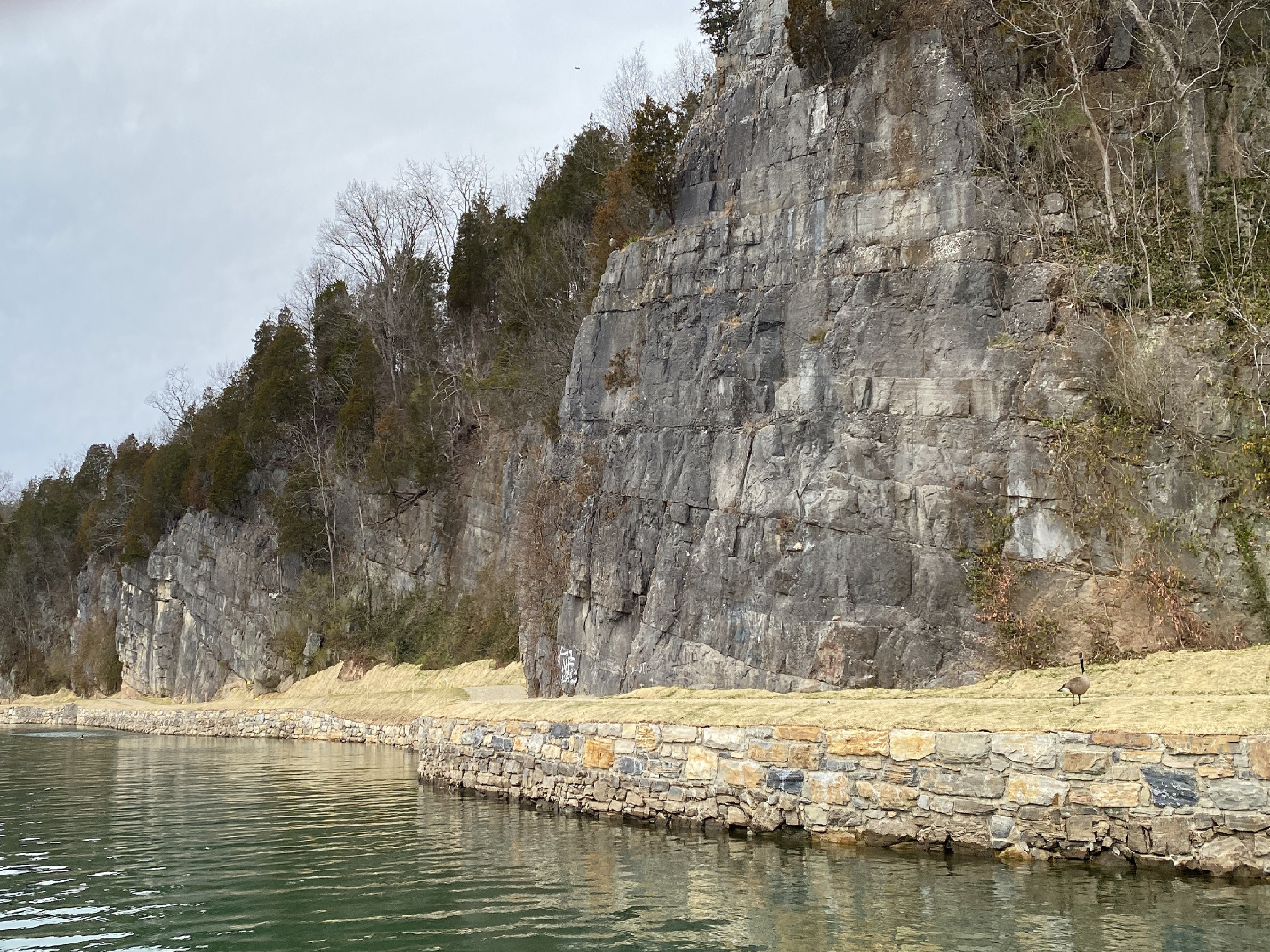 The towpath runs along a cliff face with the river in the foreground