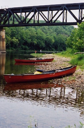Photo of canoes beached along the canal.