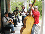 Musicians performing on the porch at the Bowles House Porch Pickin'.