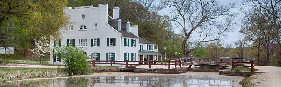 Water reflects the historic Great Falls Tavern
