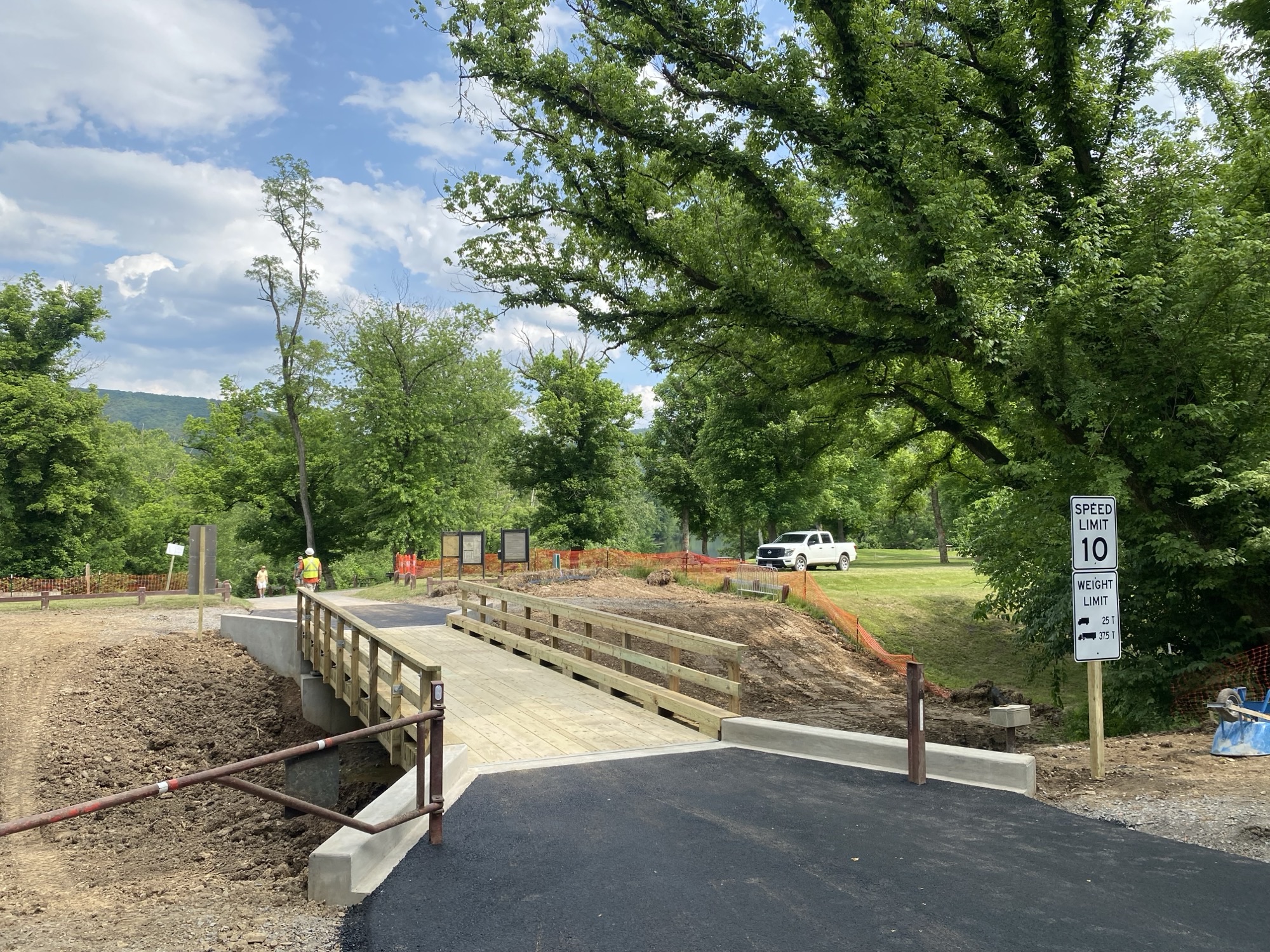 A newly reconstructed wooden bridge crossing a canal