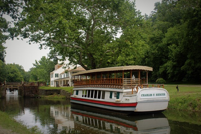 Replica canal excursion boat docked in front of the visitor center
