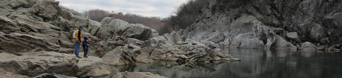 A man and boy look into the Potomac river