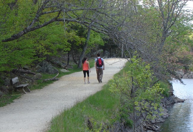 Two people walking along the towpath at Widewater.
