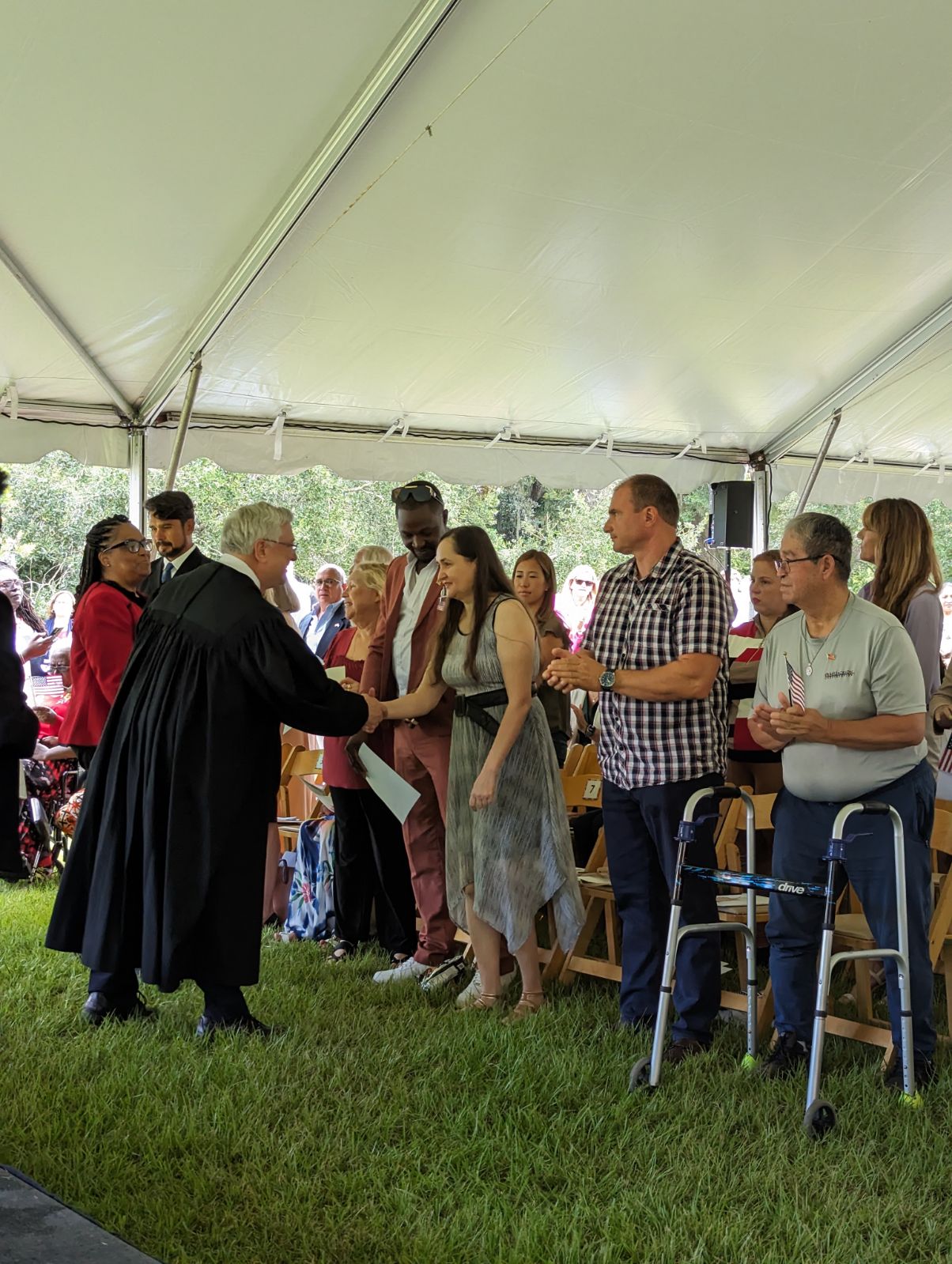 Naturalization Ceremony A judge shakes the hand of a new American citizen