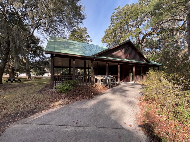 A large covered pavilion with a sidewalk leading up to it.