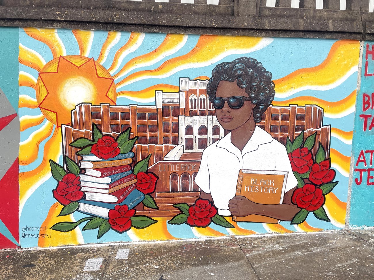 A mural depicting Elizabeth Eckford in front of Central High with books bearing the names of the Little Rock Nine.