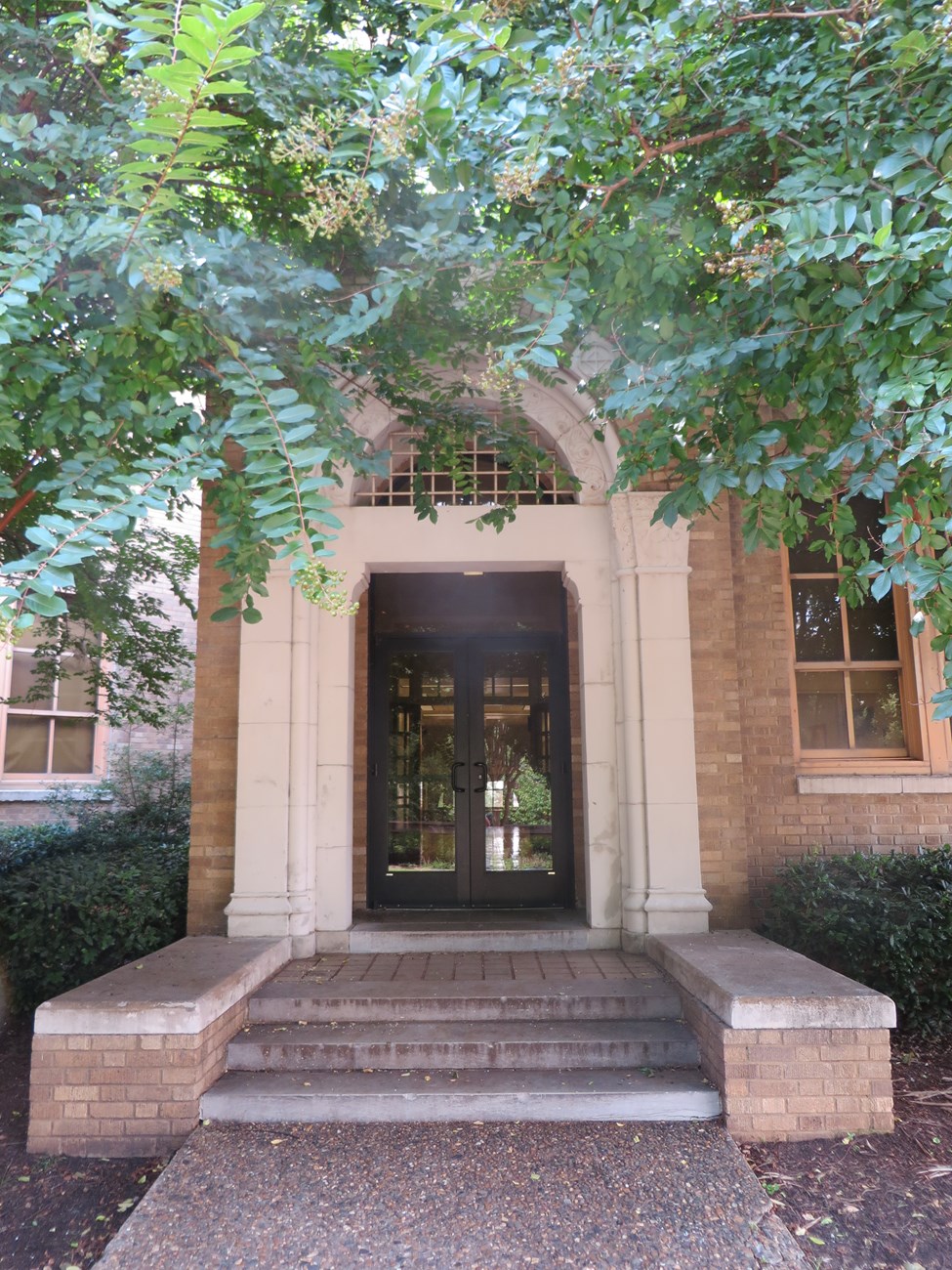 A photo of one of the arched side entrances to Little Rock Central High School.