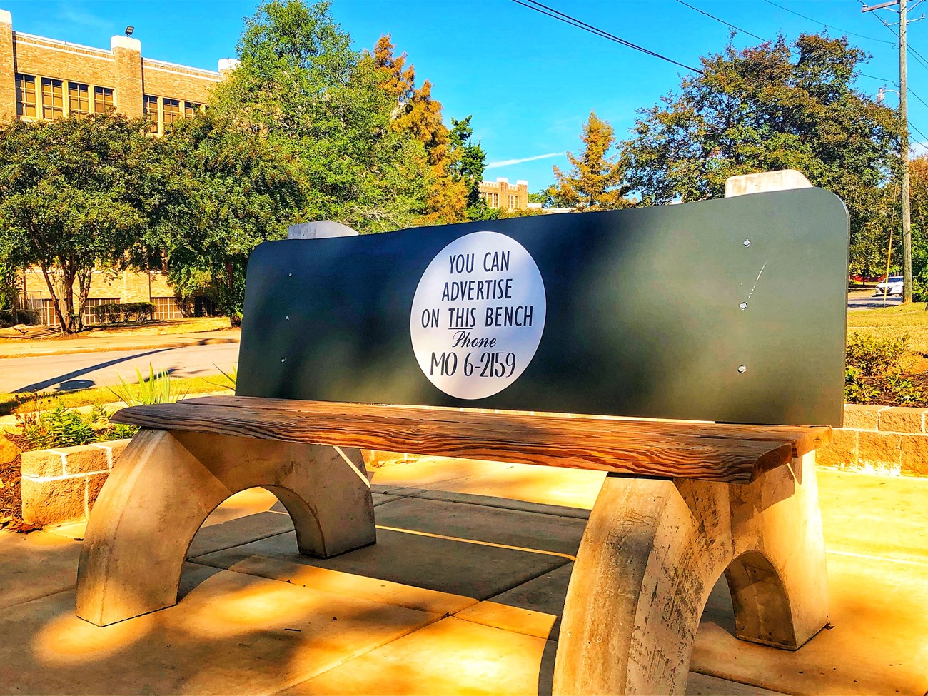 The Elizabeth Eckford Bus Bench is a wood and concrete replica of the original structure from the 1957 desegregation crisis.