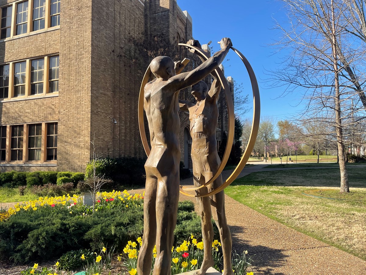 A statue on the grounds of Central High entitled "United" depicts two figures with raised arms holding rings that almost completely interlock, a symbolic reminder of the work still to be done to ensure educational equality.