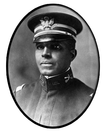 An oval portrait frame showing a man wearing a hat and uniform
