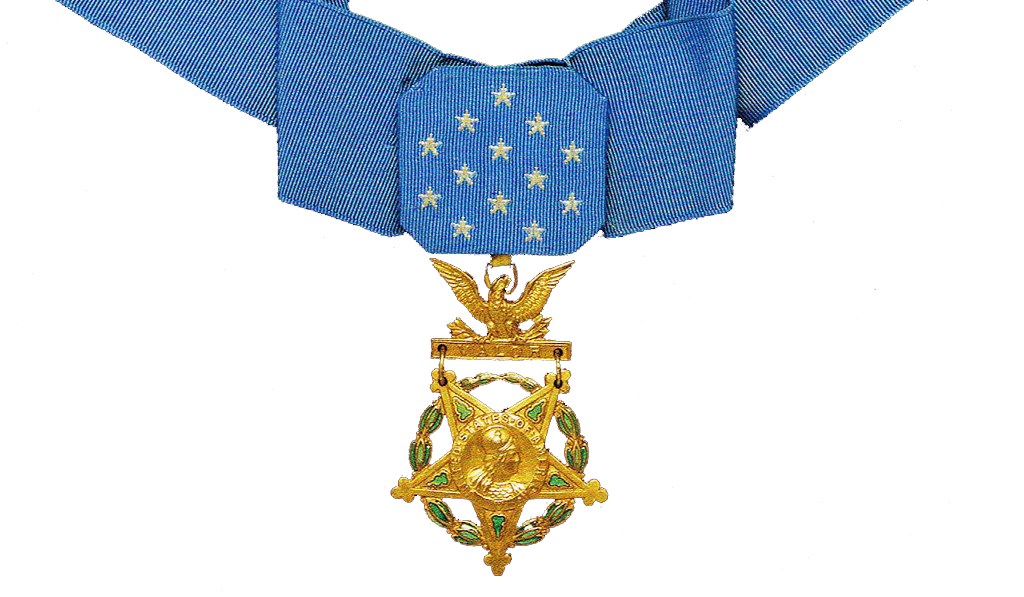 Color photograph of Medal of Honor. Medal is star shaped and gold in color hanging from a blue ribbon.