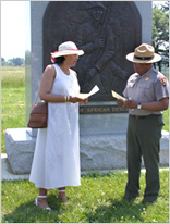 Park Superintendent and Visitor speaking in front of the Monument of Patriots of African Descent at Valley Forge